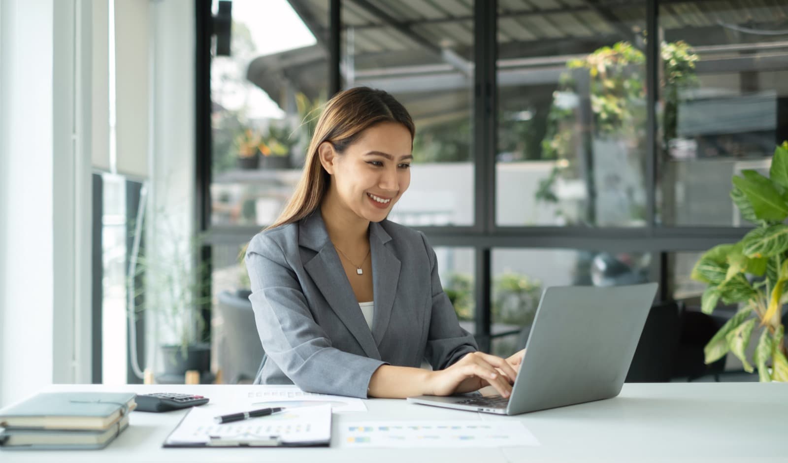 Professional working at a laptop in a bright office